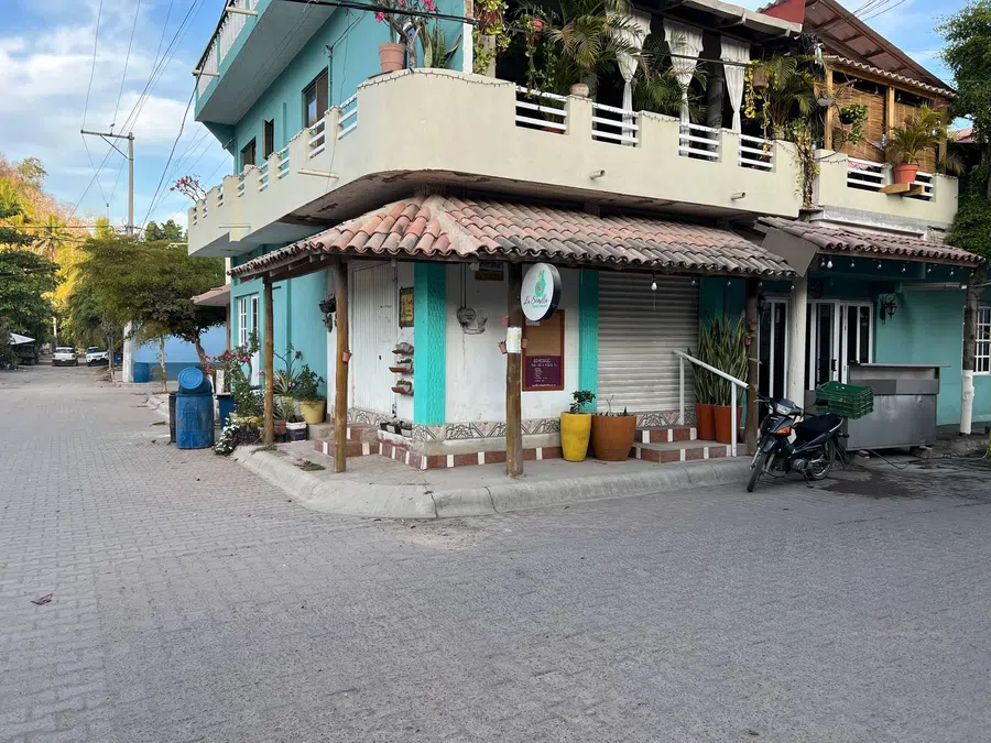 Colorful, informal architecture and shaded storefronts give La Manzanilla's streets their relaxed coastal character.