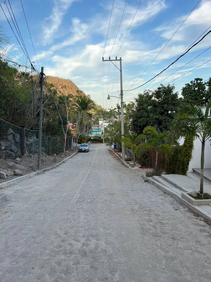 A peaceful cobblestone street climbing gently through La Manzanilla's hillside neighborhood.