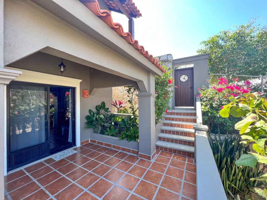 Patio in front of lower casita and door to street