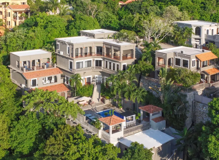 Drone view of Casa Vista de Ángeles with its multiple buildings, terraces and pool surrounded by tropical vegetation.
