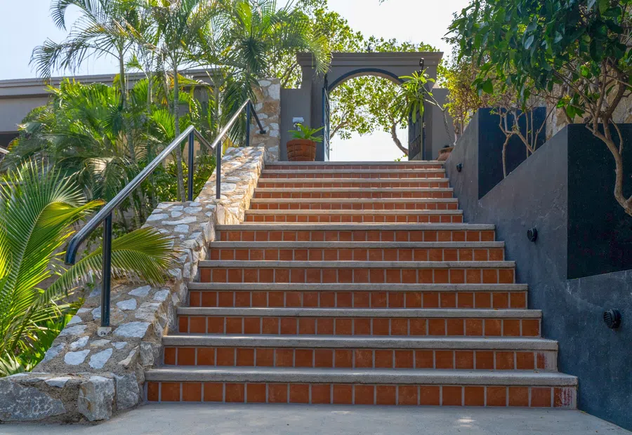 Broad tiled steps lead through the landscaped hillside compound.