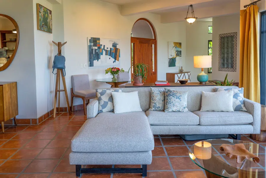 Sofa grouping and art create an inviting living area with abundant natural light.