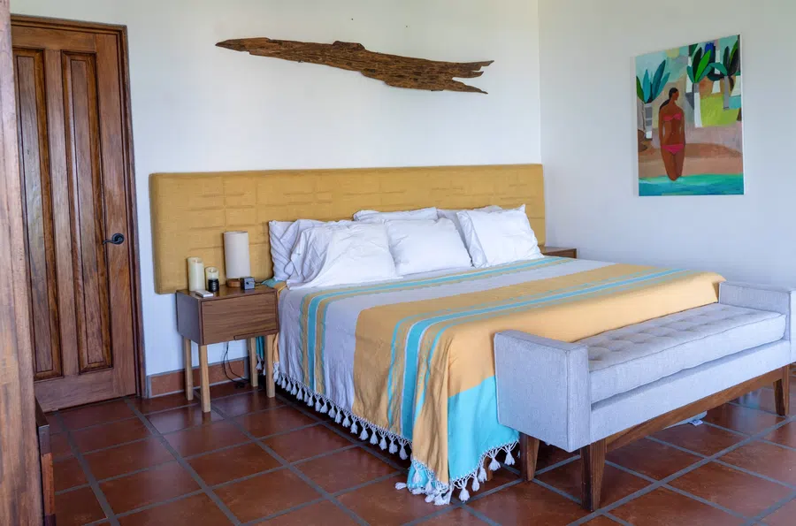 Calm, spacious bedroom with custom wood details and natural light.