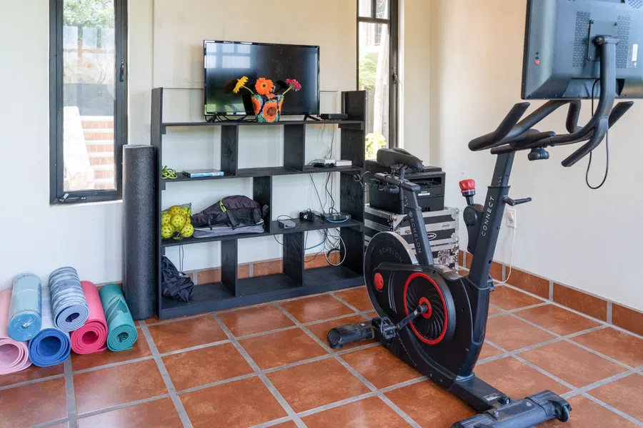 Bright first floor bedroom currently arranged as a home fitness space.