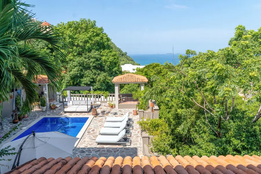Guest-residence terrace looks over the pool toward the ocean.