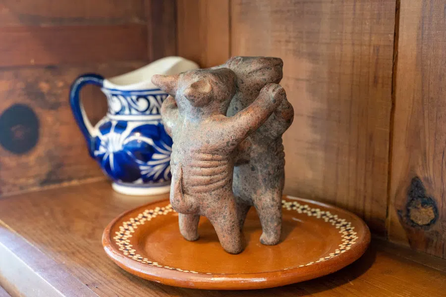 Handmade ceramic figures and blue-and-white pottery reflect the home's regional character.