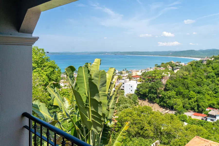 Private balcony view over lush La Manzanilla to the wide Pacific bay.