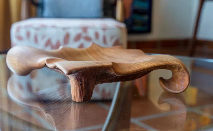 Sculptural carved-wood serving piece adds a handcrafted touch to the interior.