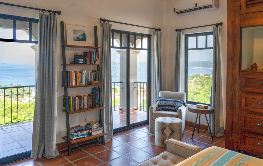 Master bedroom opens through large doors to a private balcony and Pacific view.