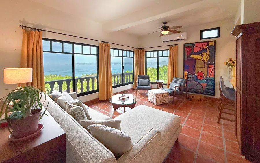 Wide-angle view of the main living room opening toward the ocean-facing balcony.