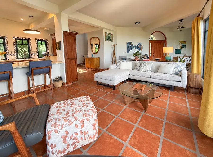 Wide view connecting the main living room, dining area and kitchen.